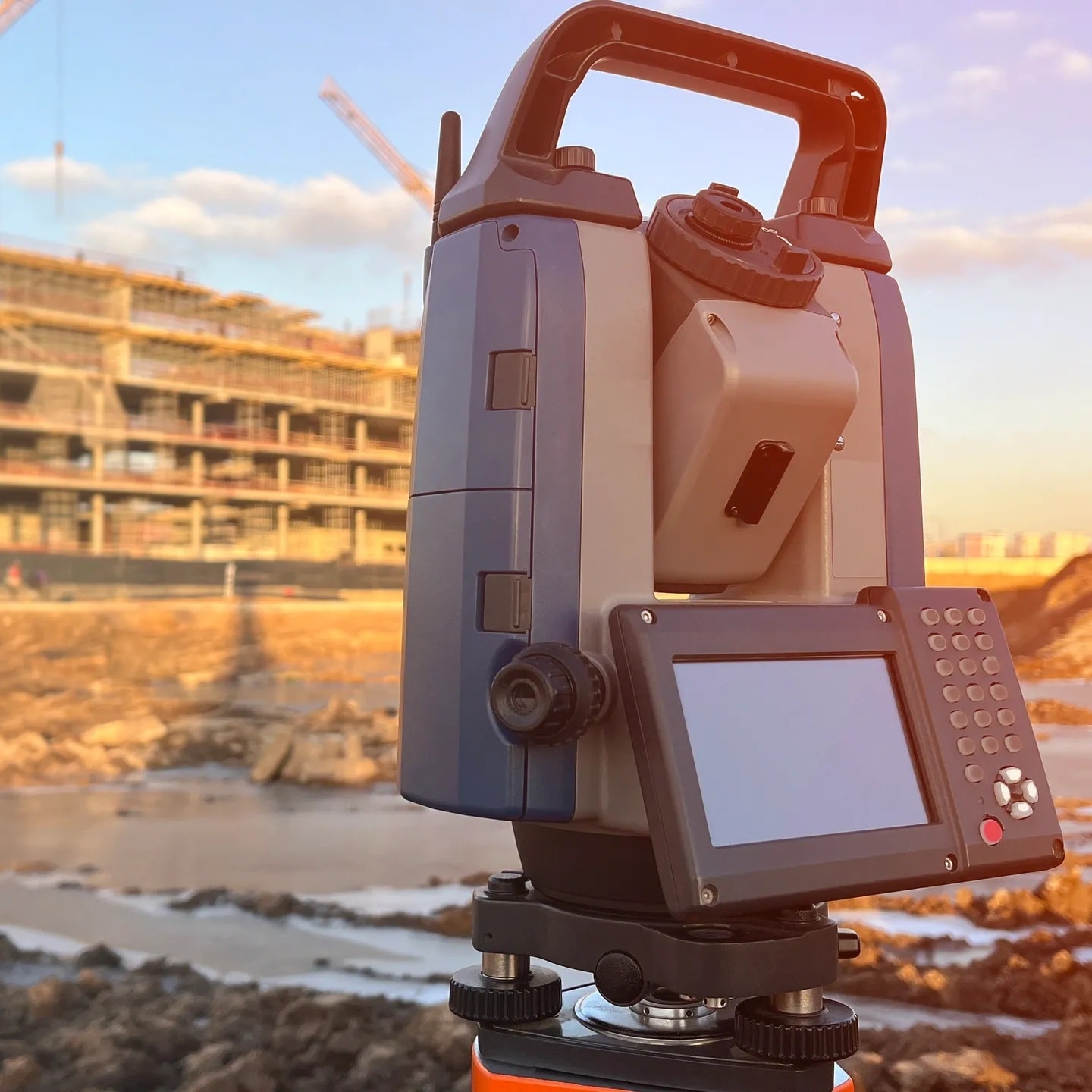 Land surveyor using total station equipment in the field